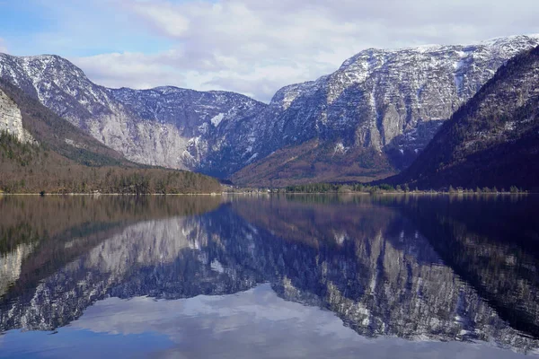 stock image Hallstatt, Hallstetter Lake, Austria - March 2023: Nice view of the city. Mountain Lake. Lake among the mountains. Huts in the mountains near the forest lake.