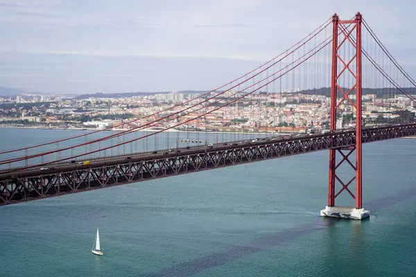 stock image Lisbon, Portugal - March 2023: View of the April 25 Bridge and the city of Lisbon. 25 de Abril Bridge.