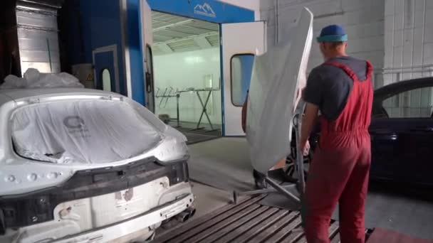 キエフ ウクライナ 2023年8月12日 車のサービスステーションでペイントショップ ペイントショップマスター ペイントブースで車を描く 絵画の後の分解された車 — ストック動画