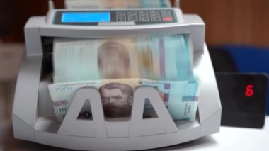 Banknotlar için sayma makinesi. Ukrayna parası bir hesap makinesinde. Ukrayna para biriminin dönüştürülmesi. Ukrayna parası banknotlar için bir makine tarafından sayılır. Ukrayna Hryvnia 'sı.