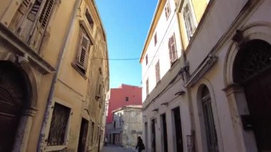Pula, Hırvatistan - 3 Kasım 2024: Evleri olan bir şehir caddesi manzarası. Şehrin merkez caddesi..