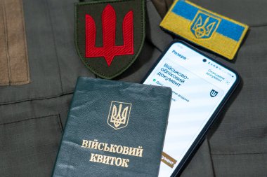 Ukrainian military ID and mobile application Reserve. Ukrainian military ID and smartphone. Documents of a serviceman of Ukraine. Military ID Ukraine. clipart