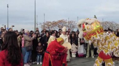 Marsilya, Fransa 2 Şubat 2025: Katedral önünde Ay Yeni Yılı kutlaması. Geleneksel bir Çin aslanı dansı gösterisinde seyirciler avro banknotları tutuyor.