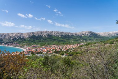 KRK Island, Baska, Croatia - April 18, 2025: View of the mountains and the village of Baska.