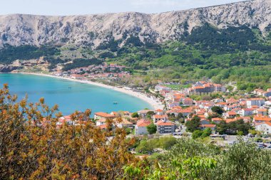 KRK Island, Baska, Croatia - April 18, 2025: View of the mountains and the village of Baska.