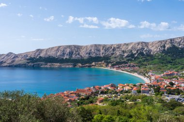 KRK Island, Baska, Croatia - April 18, 2025: View of the mountains and the village of Baska.