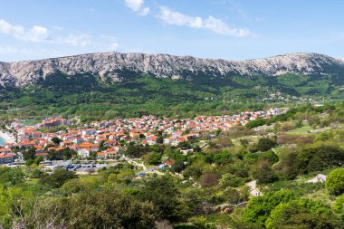 KRK Island, Baska, Croatia - April 18, 2025: View of the mountains and the village of Baska.