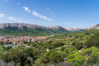 KRK Island, Bashka, Croatia - April 18, 2025: View of the mountains and the village of Bashka. Panorama of beautiful mountains and the sea.