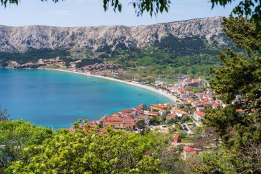 KRK Island, Baska, Croatia - April 18, 2025: View of the mountains and the village of Baska.