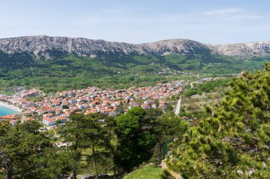KRK Island, Baska, Croatia - April 18, 2025: View of the mountains and the village of Baska.