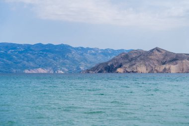 KRK Island, Bashka, Croatia - April 18, 2025: View of the mountains and the village of Bashka. Panorama of beautiful mountains and the sea.