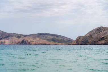 KRK Island, Bashka, Croatia - April 18, 2025: View of the mountains and the village of Bashka. Panorama of beautiful mountains and the sea.