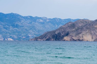 KRK Island, Bashka, Croatia - April 18, 2025: View of the mountains and the village of Bashka. Panorama of beautiful mountains and the sea.