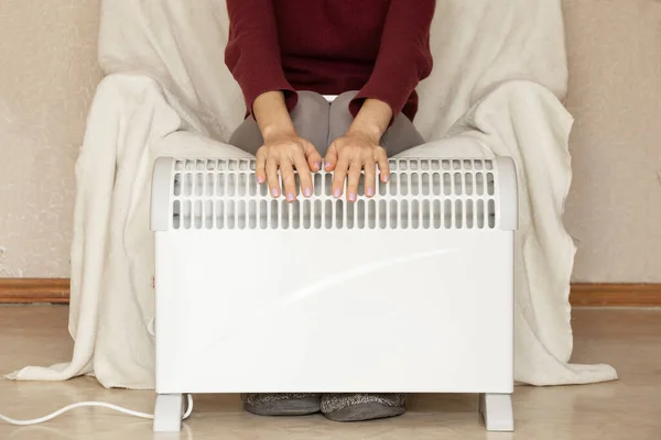 Girl Sits Armchair Puts Her Hands Warm Convector Apartment Winter — Stock Photo, Image