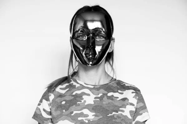 A military girl in a camouflage T-shirt and a faceless mask on a white background, a military girl