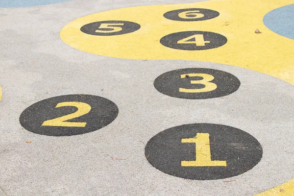 Childrens game with numbers in circles on the playground on the roads for jumping in Ukraine, playground, game for children