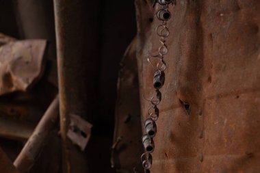 Exploded bullets in a cartridge belt inside an exploded Russian tank in Ukraine, a Russian tank and weapons