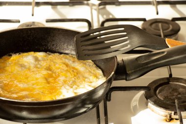 Omelette in a frying pan on a gas stove at home in the kitchen ,cook food
