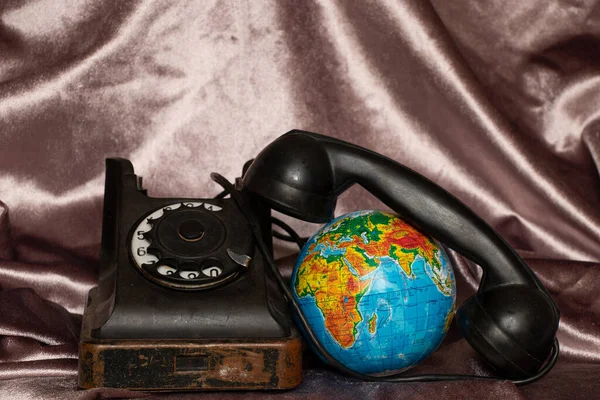 Old phone and globe in Ukrainian language