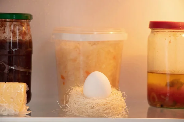 Satu Telur Ayam Putih Dalam Sarang Jerami Terletak Rak Lemari — Stok Foto