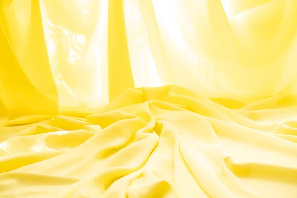 Yellow crumpled plain fabric as a background