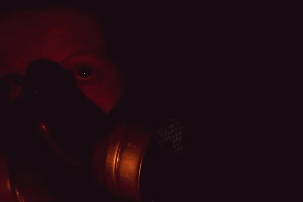 一个戴着防毒面具的女孩在黑暗中的脸 对生命构成威胁 — 图库照片