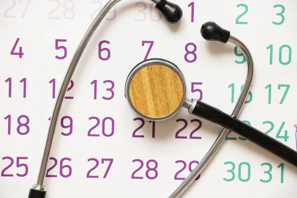 Stethoscope lies on a calendar, health and medicine