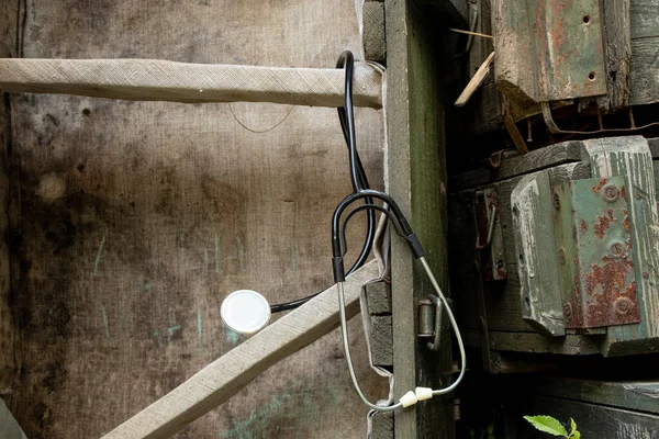 A stethoscope hangs on green ammunition boxes in the war, a military doctor, diagnostics