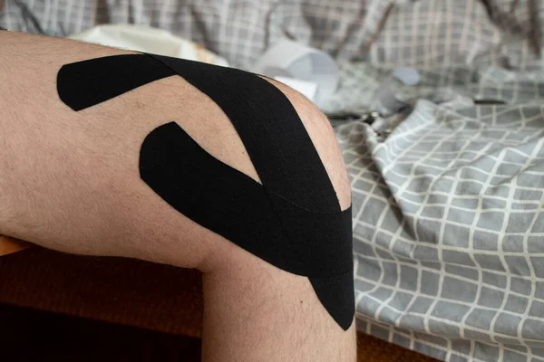 Knee taping after knee surgery and meniscus replacement, rehabilitation and recovery after surgery