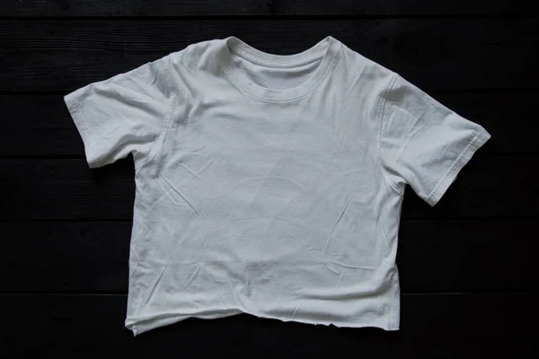 Biały Pognieciony Shirt Leży Czarnej Planszy Mody Stylu — Zdjęcie stockowe