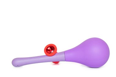Red silicone smooth butt plug and anal douche, sex toy, on a white background. Contrast photo of anal toys, erotic toys, enema and butt plug