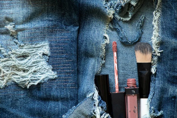 Hole makeup set in ripped jeans, makeup and style, glitter and mascara and brush, fashion
