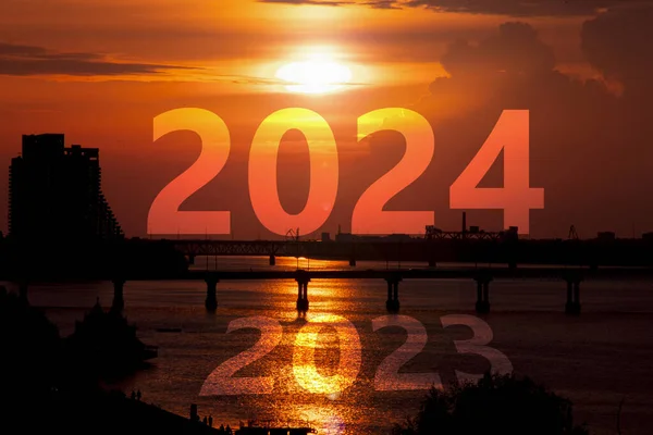 2024 against the sky at dawn in the city of Dnipro in Ukraine and the year 2023 against the backdrop of the Dnieper River, the beginning of a new year in Ukraine, dawn and success, freedom