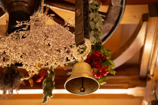 One small bell hanging on the ceiling with flower wreath as home decor,tradition and holiday home decoration