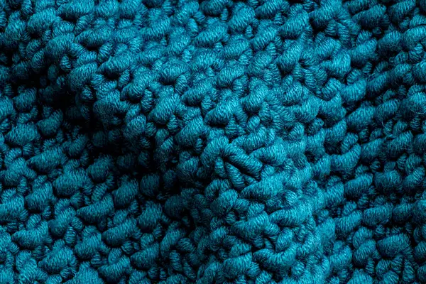 Simple blue wavy background made of large knitted thread, trend and fashion, knitted clothing, Neutral background