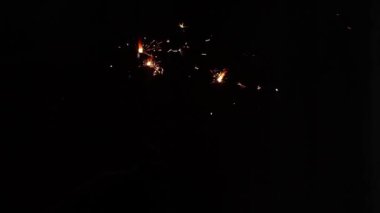 Ukrayna 'da karanlıkta, yeni yılı kutlayan bir adamın elinde maytap.