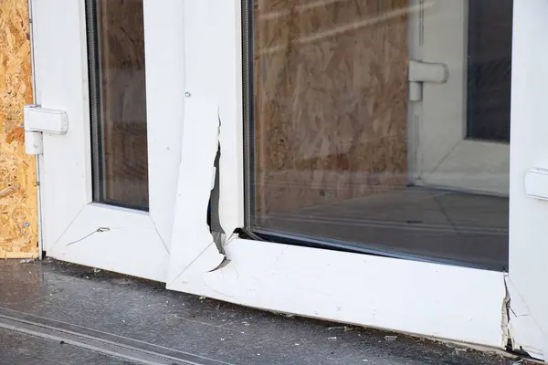 A metal-plastic glass door broken from a blast wave during a missile attack on the Dnieper in Ukraine, war in Ukraine