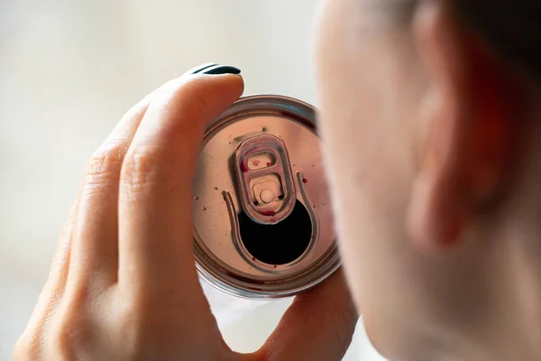 A girl drinks an alcoholic drink from a tin bottle close-up,drink