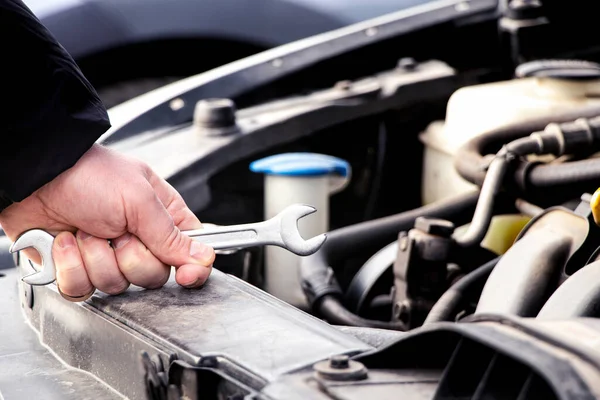 Car care, maintenance and repair, auto mechanic, hand and wrench for car repair, engine problem and diagnosis, car repair