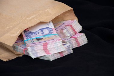 Bir deste Ukrayna Hryvnia 'sı siyah bir arka planda, para ve kâr üzerine kuruludur, 200 Hryvnia demet halinde.