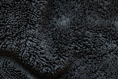 Döngü dokusuna sahip siyah Terry kumaş arka planı, tasarım ve sunumlar için yumuşak tekstil şablonu