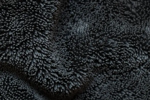 Döngü dokusuna sahip siyah Terry kumaş arka planı, tasarım ve sunumlar için yumuşak tekstil şablonu