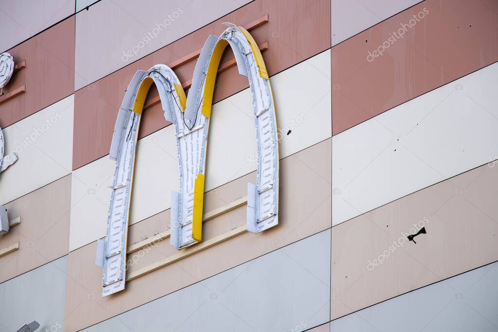 Ukraine Dnipro 12/30/2023 - Damaged McDonald's sign on the facade of a shopping center after a rocket attack with a blast wave, terror on people