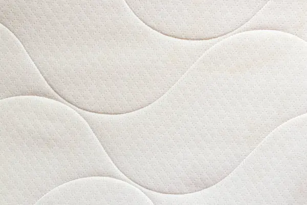 Dalga dikişli ve kumaş desenli bir yatağın hafif arkaplanı