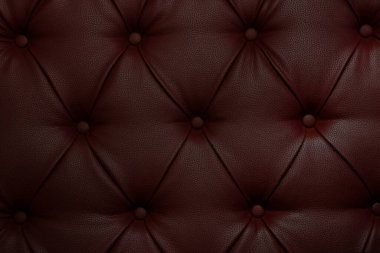 Dekoratif düğmeli koyu kırmızı deri döşeme, arka plan ve iç mekan için desenli yüzey.