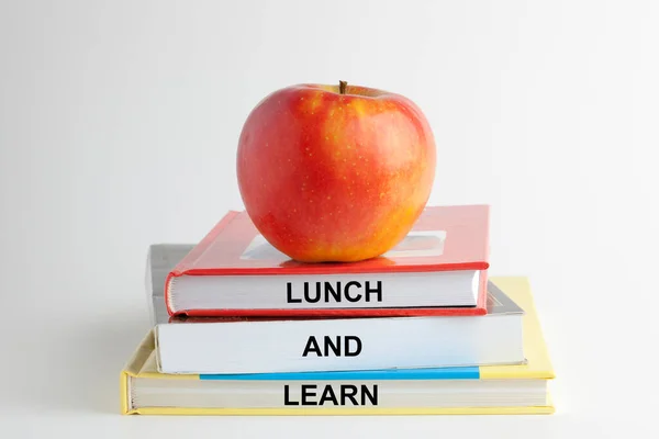 Books with words lunch and learn on white background. Business, educational and learn concept.