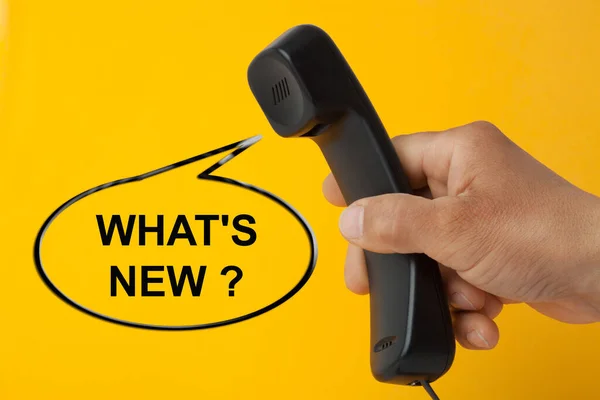 What\'s new question in speech bubble with hand holding telephone handset.