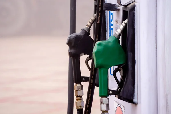 old damaged fuel pump nozzle showing petrol and deisel in india as the price increases and electric vehicles take over globally