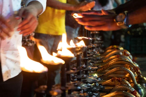 stock image LIne of fire oil lamps on the ghat of ganga in rishikesh where people take blessings by passing their hands over the fire in Hinduism in India