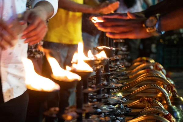 Stock image LIne of fire oil lamps on the ghat of ganga in rishikesh where people take blessings by passing their hands over the fire in Hinduism in India